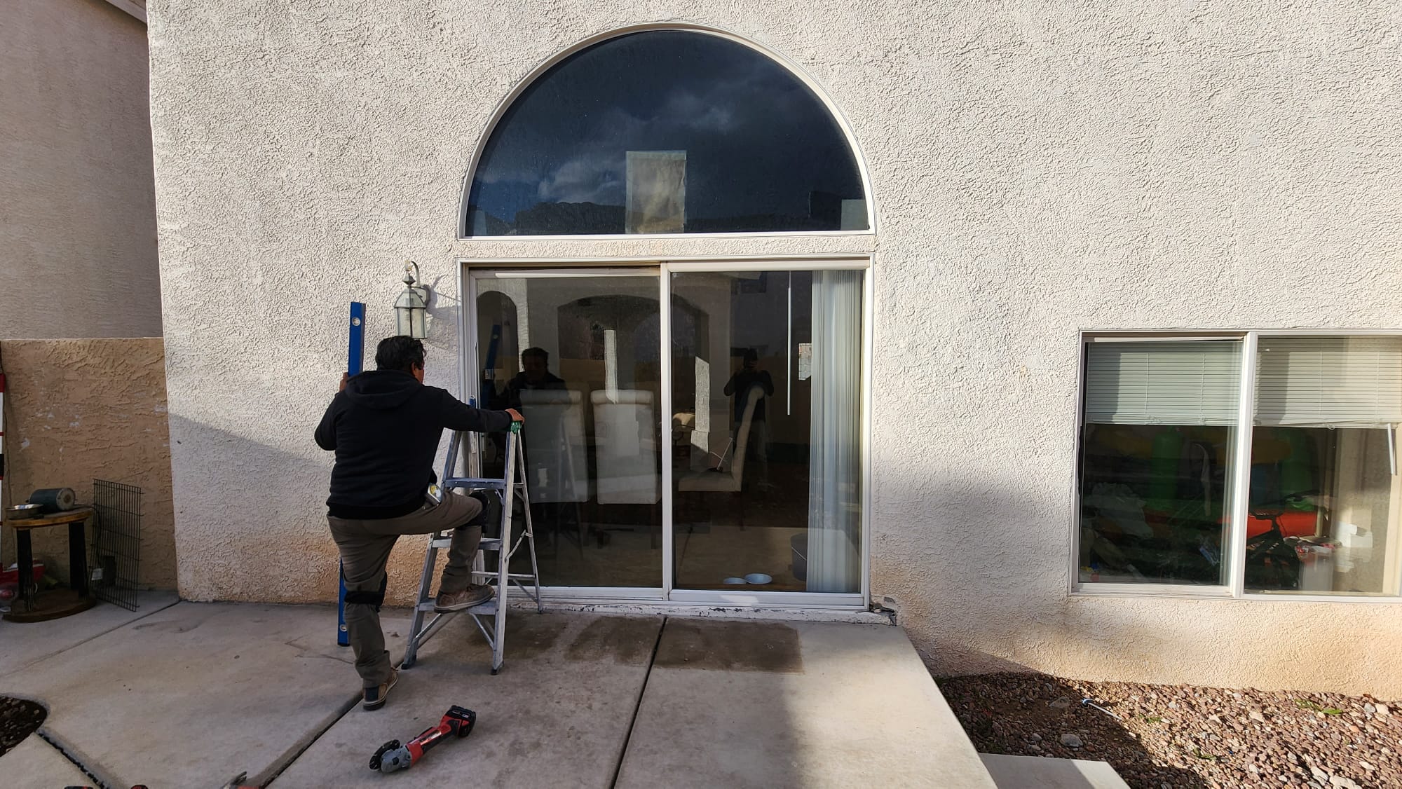 New sliding door installed under an arched transom window